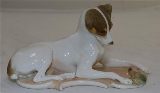 A Nymphenburg polychrome figure of a recumbent hound and frog, modelled by T. Karner, late 20th century, length 17cm (6.7in.)